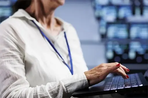 System admin working laptop setting up high bandwidth dedicated multiplayer gaming servers high tech facility accommodate more traffic from worldwide locations avoid lag close up 1 768x512.jpg